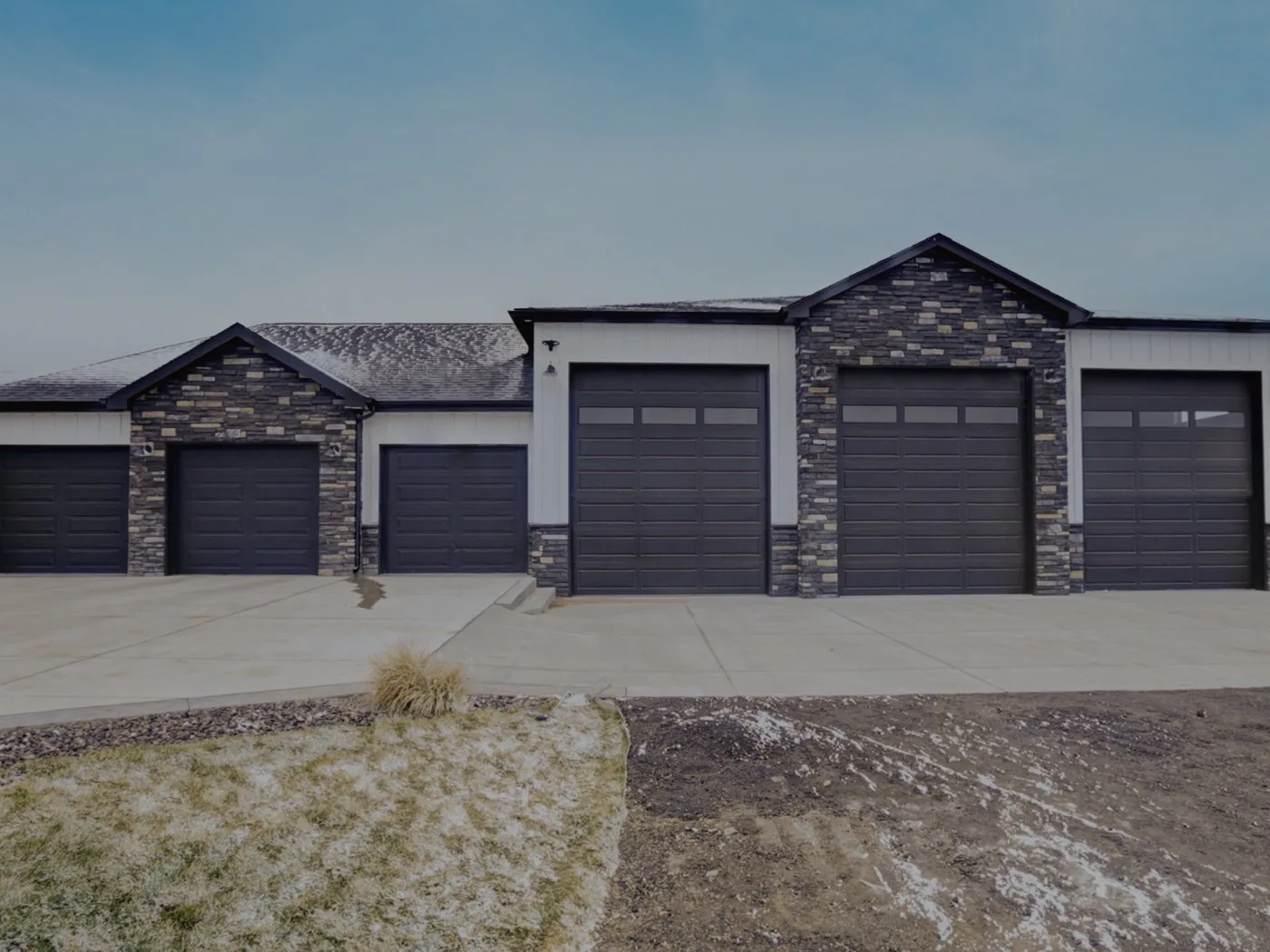 A large attached garage addition with stone accents